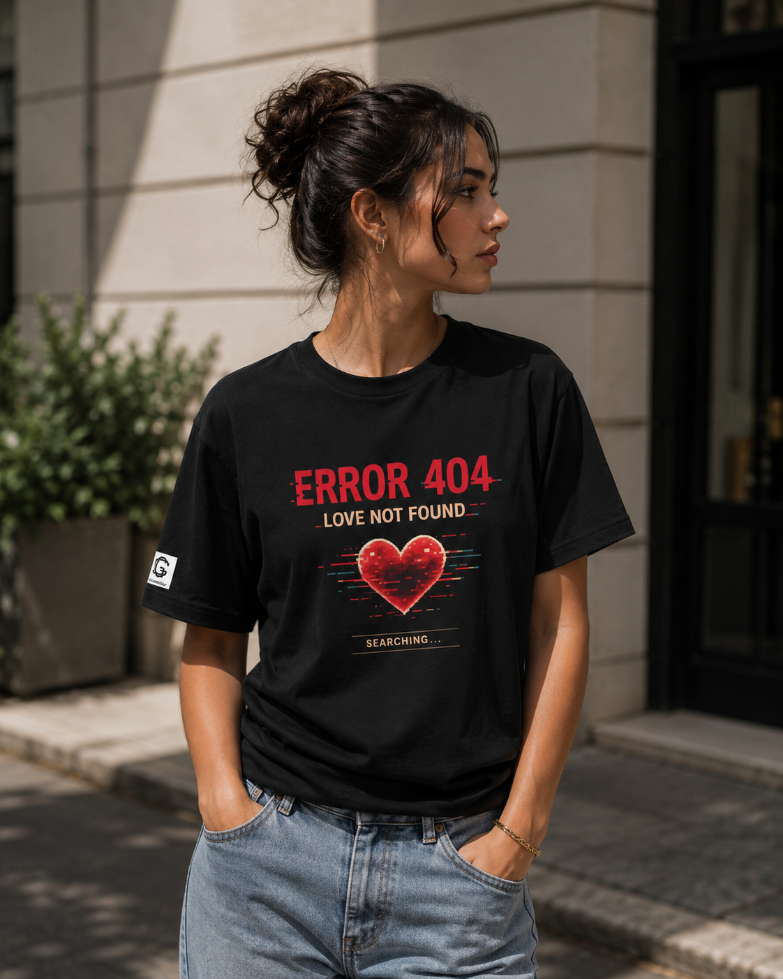 Woman wearing a black t-shirt with 'ERROR 404 LOVE NOT FOUND' design outdoors.